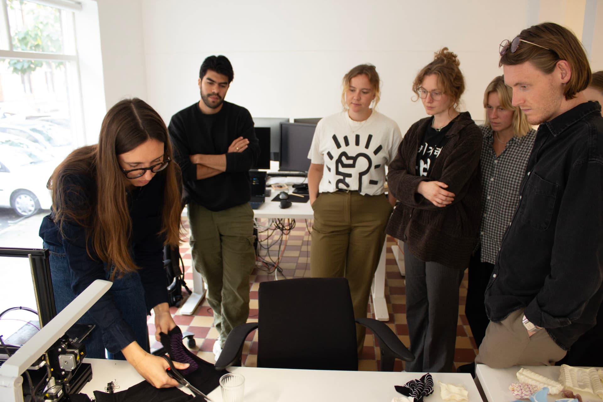 Participants watching a 4D textile printing demonstration at a public city festival.