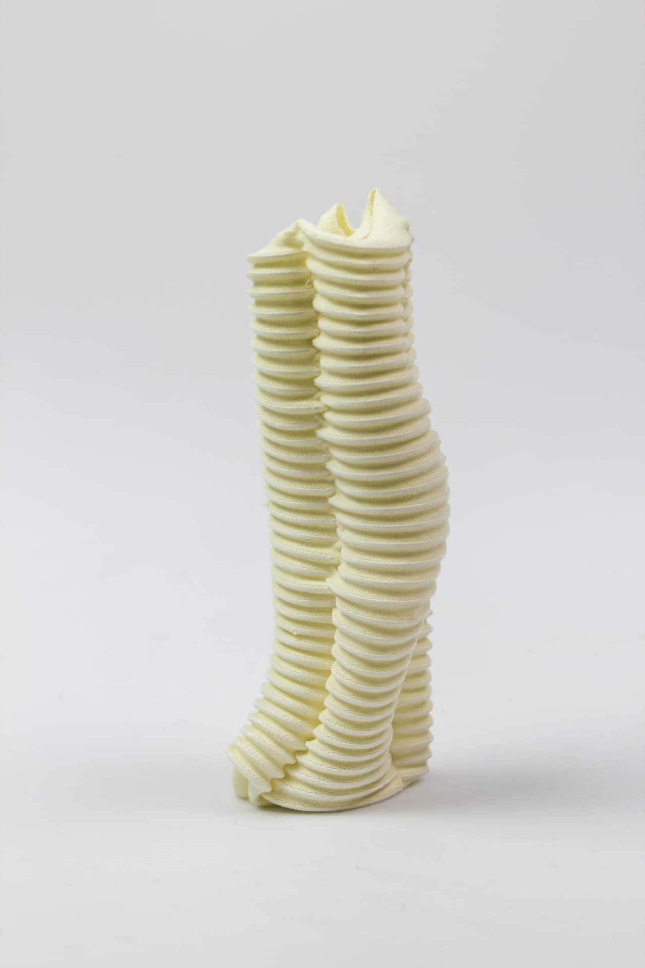 Ribbed pale yellow textile column seen from a second angle.